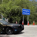 Alligator-alcatraz-sign-and-trooper-car-scaled-2