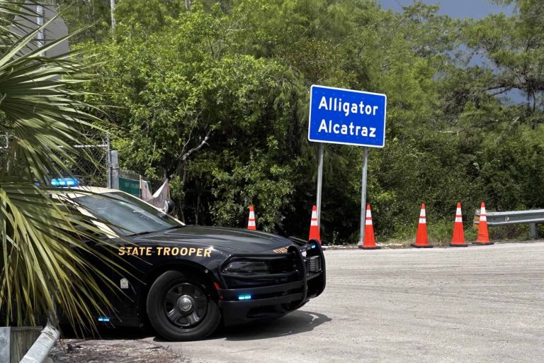 Alligator-alcatraz-sign-and-trooper-car-scaled-2
